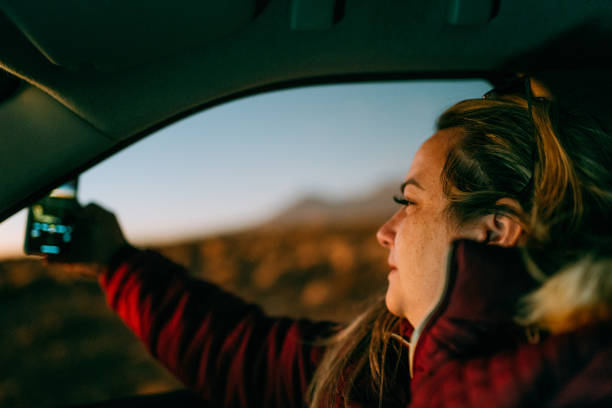 istock Woman filming car journey through window 1878702776