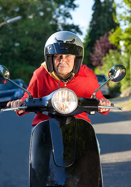 istock Senior woman riding a scooter. 187870686