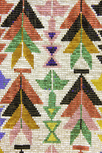 Beaded Shawnee Native American warrior clothing decoration dating to 1830s - typically part of a breastplate, headdress or headband.  The original Shawnee homeland was Ohio, Kentucky, and Indiana. But the Shawnee were far-ranging people, with villages as far north as New York state and as far south as Georgia. Today most Shawnee live in Oklahoma, having been transferred there by the US government.  Originally, beads were carved from natural materials like shells, coral, turquoise and other stones, copper and silver, wood, amber, ivory, and animal bones, horns, and teeth. Glass beads were not used until the colonists brought them from Europe 500 years ago, but like horses, they quickly became part of American Indian culture. Today glass beads, particularly fine seed beads, are the primary materials for traditional Shawnee beaders.