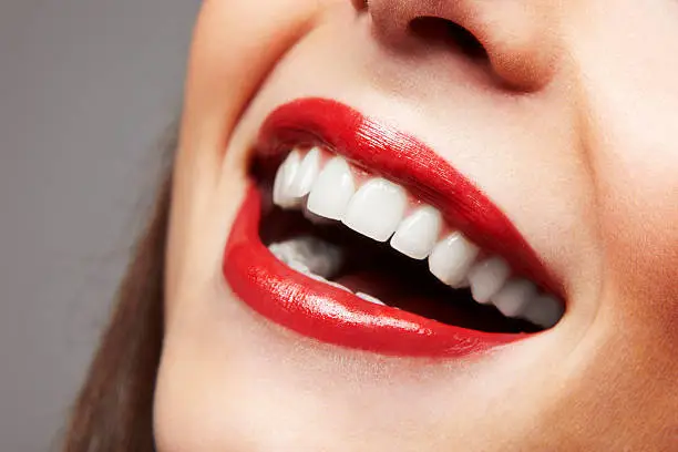 Photo of Smiling woman mouth with great teeth. Over white background