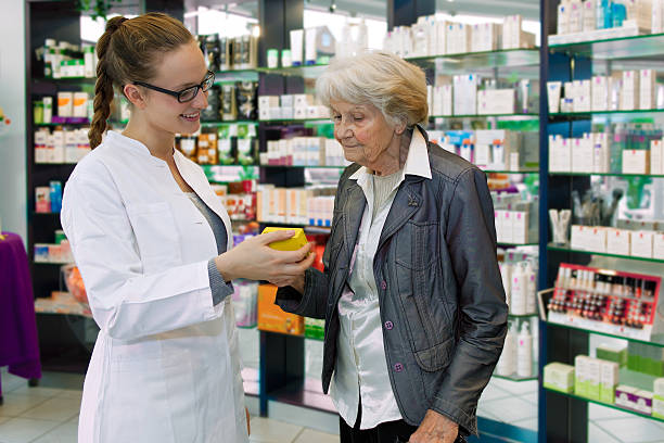 istock Pharmacist advising medication to senior patient. 187873471