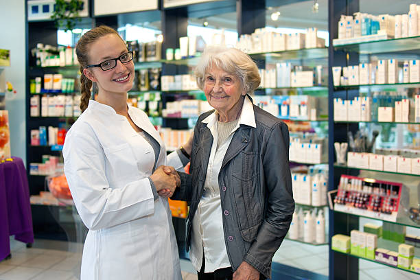 istock Senior lady shaking hands with a pharmacist. 187874515