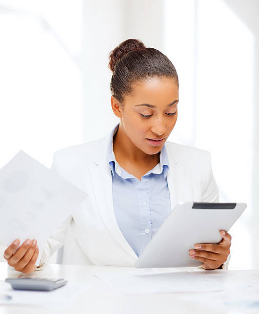 istock businesswoman with tablet pc in office 187874798