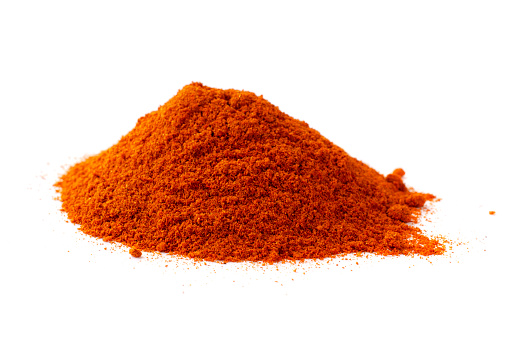 Red pepper powder isolated on white background, top view. Heap of red pepper powder on white background. Red paprika, powder, isolated on white background. Pile of red paprika