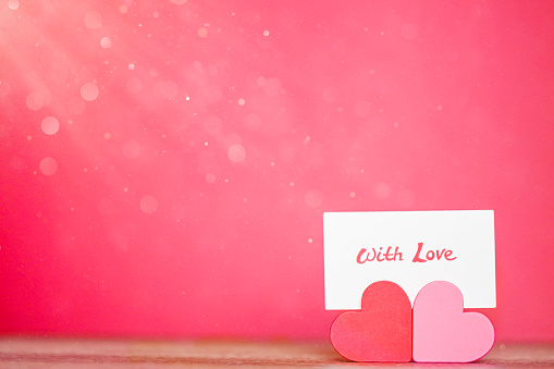Love and hearts. For Valentine’s Day, love, engagement storytelling, greeting cards. With love note and copy space.