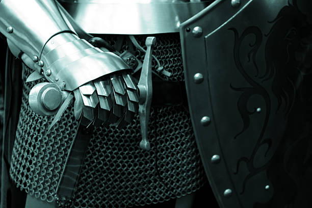 A knight in steel armor posing with his sword and shield