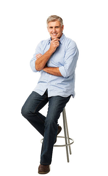 istock Smiling Man With Hand To Chin Sitting On Stool 187878809