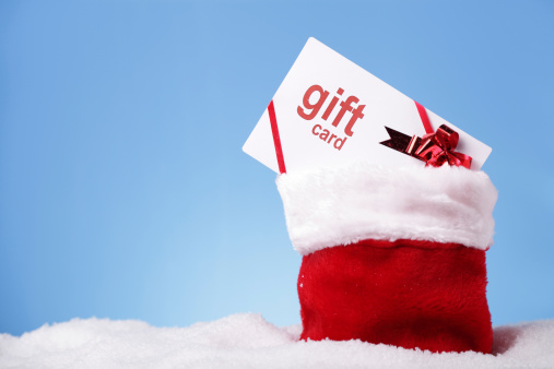 Gift card in Santa's sack on snow