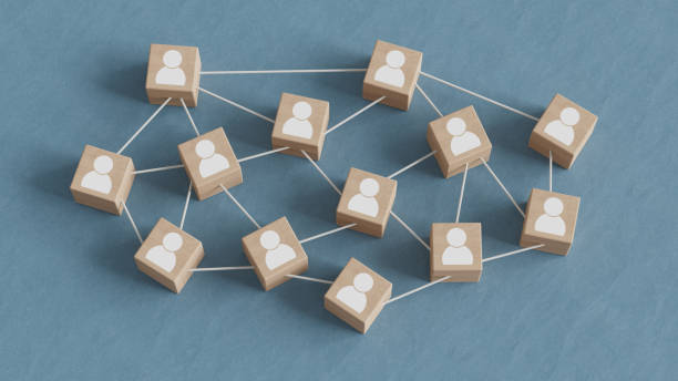 istock Teamwork concept with wooden blocks connected together with white tubes on a blue textile background. 1878827572