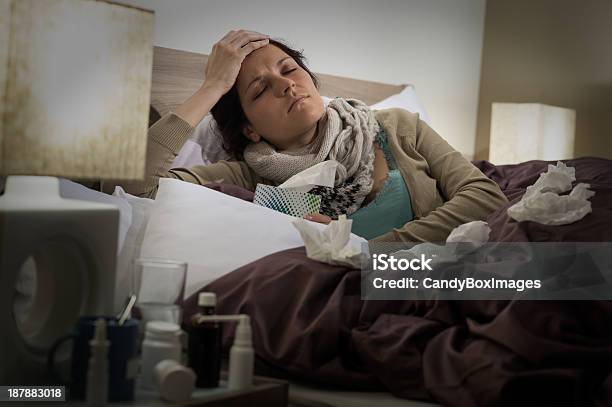 Enfermo En Cama De La Gripe Mujer Que Sufre De Dolor De Cabeza Foto de stock y más banco de imágenes de Acostado