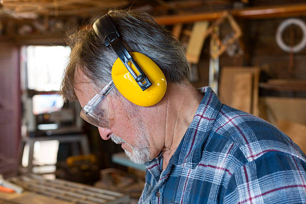 istock Carpenter with protective glasses and ear muffs. 187884260