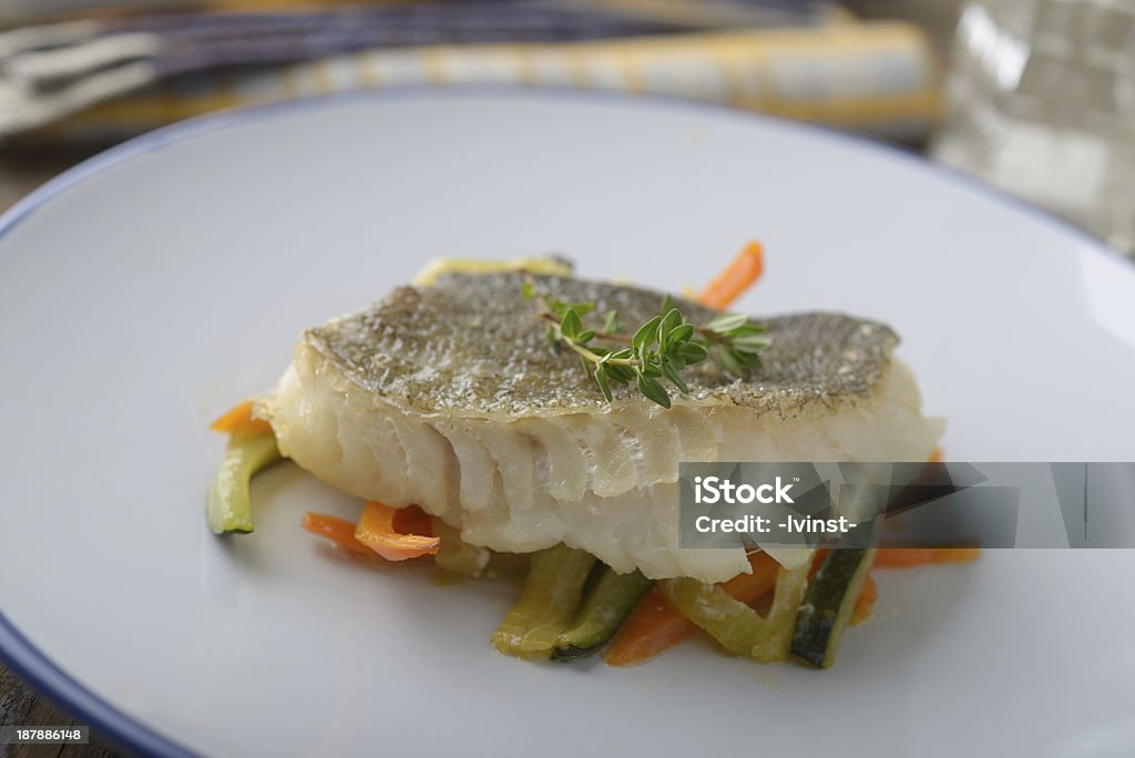 Baked cod with vegetables Baked cod on vegetable bed Baked Stock Photo