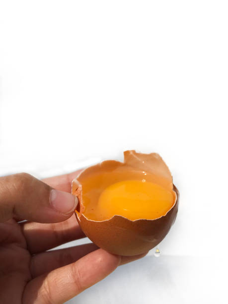 istock A woman's hand cracks an egg to separate the egg white and yolk 1878869979