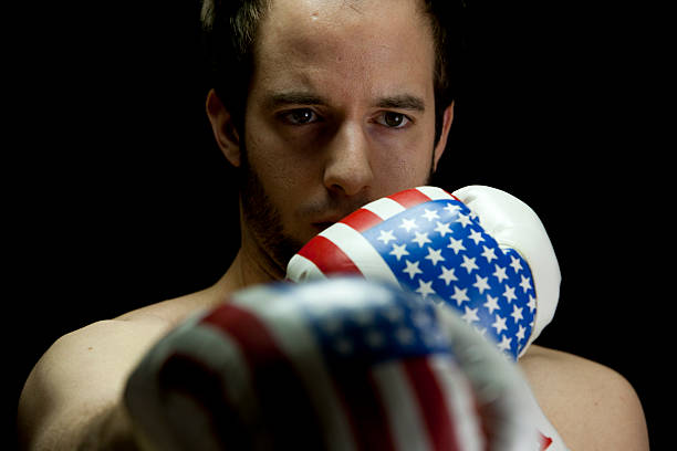 istock boxer with USA flag boxing gloves (low-key studio shot) 187887057