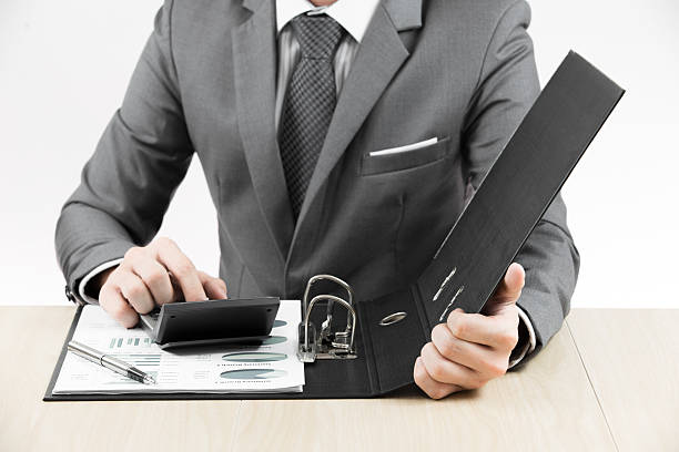 istock man hand with pen and business report 187888085