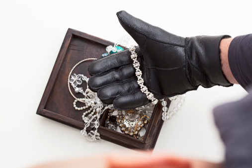 Burglar is stealing expensive jewelry