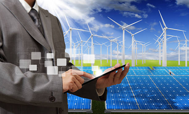 istock Man with tablet against renewable energy backdrop 187892264