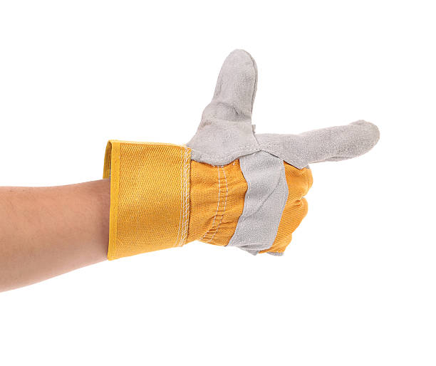 istock Hand in gloves holds as gun. 187896549