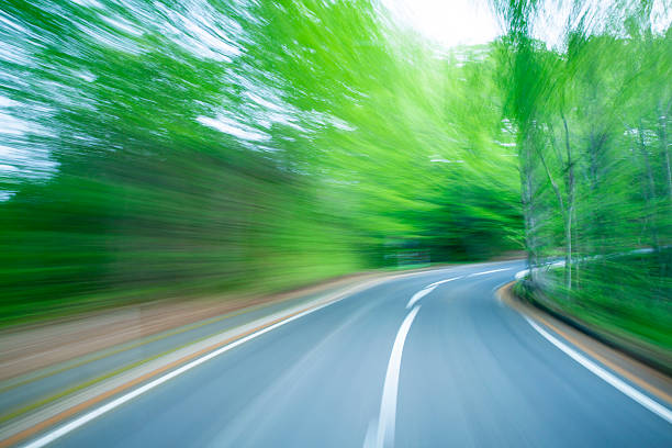 istock Road in motion blur at green forest 187898014