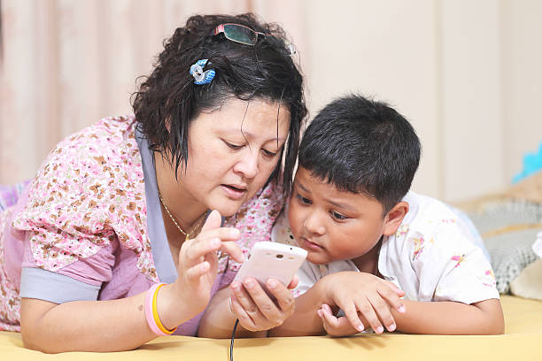 istock Asian mother and son. Playing smart phones 187898131