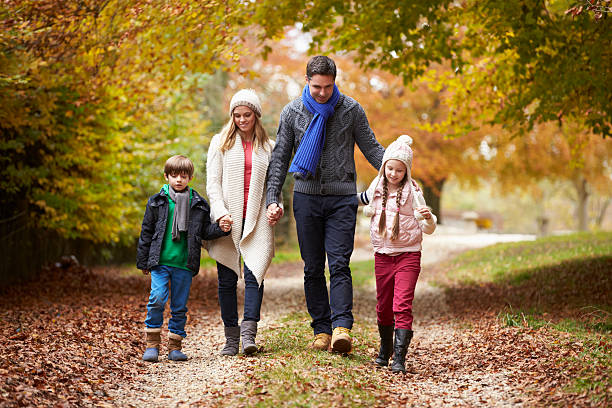 istock Family Walking Along Autumn Path 187898856