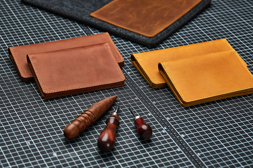 Handmade products made of genuine yellow and red leather. Leather passport cover, leather wallet. Leather goods for men. The view from the top.