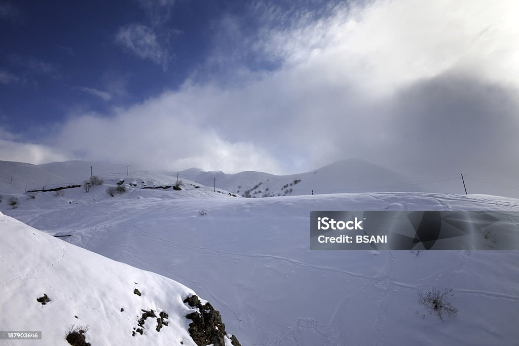 Off-piste slope and mountains in haze Off-piste slope and mountains in haze. Caucasus Mountains, Georgia, ski resort Gudauri. Back Country Skiing Stock Photo