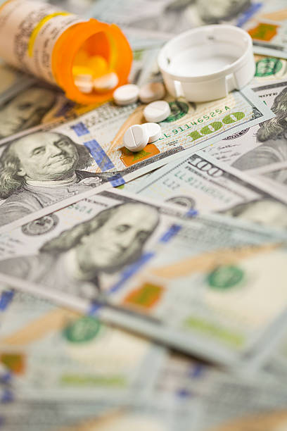 istock Medicine Pills Scattered on Newly Designed One Hundred Dollar Bi 187903682