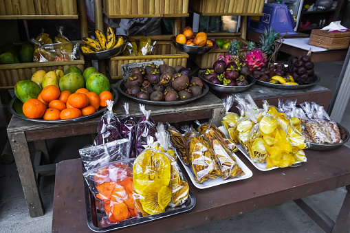 Small stall selling various types of fresh fruit and various snacks. Fruits for sale on the public traditional market.