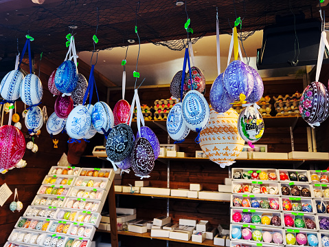 Hanging Easter eggs on strings under the roof of a market stall, an example of home decoration