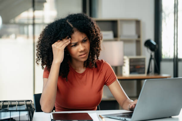 istock Business woman is stressed, bored, and overthinking from working on a tablet at office. 1879074106