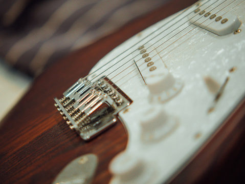 Adjustment knobs in the panel of an electric guitar amplifier, close up with selective focus