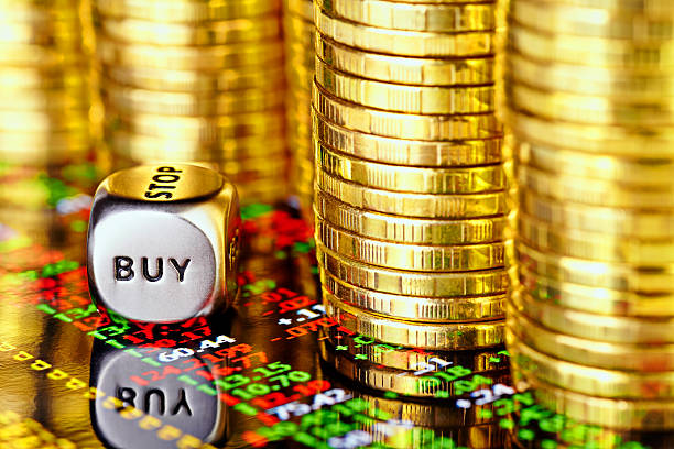 Golden coins, financial chart and dices cube Golden coins, financial chart and dices cube with the word BUY. selective focus gold ira reviews stock pictures, royalty-free photos & images