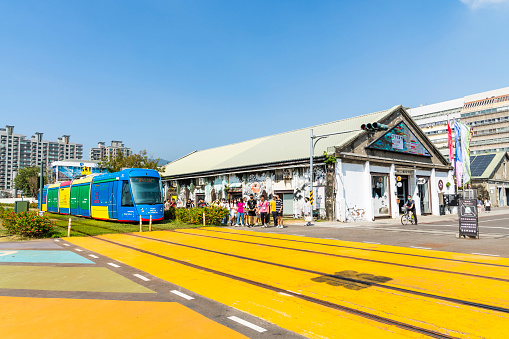 Kaohsiung, Taiwan- November 2, 2023: The circular light rail train drives past Pier-2 Art Center in Kaohsiung, Taiwan.