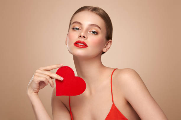 istock Beautiful woman holding an artificial red heart 1879102484
