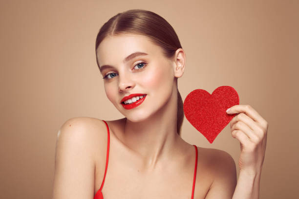 istock Beautiful woman holding an artificial red heart 1879104665