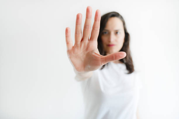 Young woman showing stop gesture