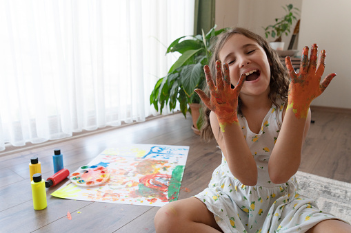 Hands covered in tempura paint.