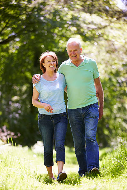 istock Senior Couple Walking In Summer Countryside 187913257