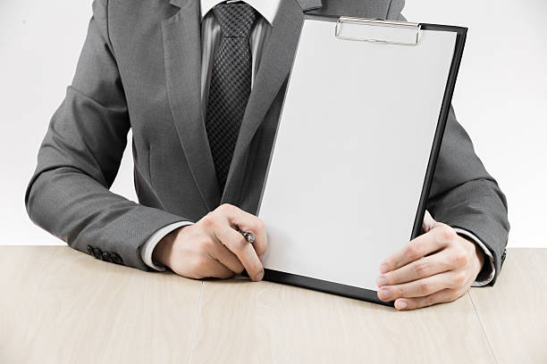 istock man hand with pen and business report 187915261