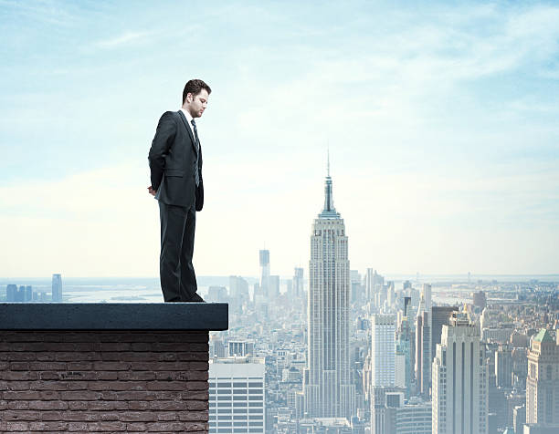 istock businessman standing on roof 187916770