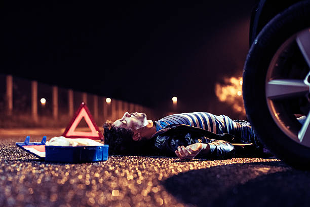 istock Car accident with dead pedestrian lying on the street 187916883