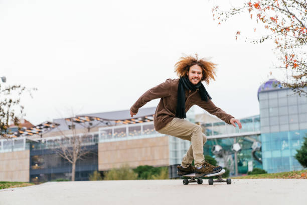 istock Joyful Redhead Man Skateboarding in Urban Park 1879171658