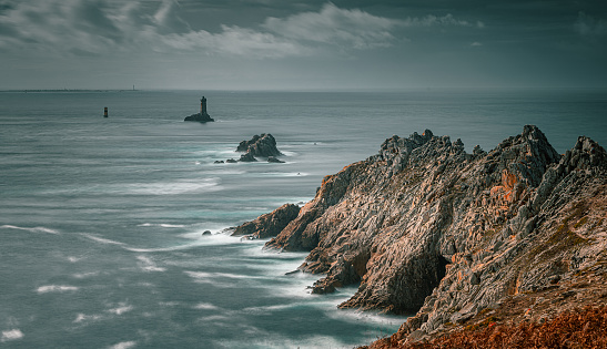 The Pointe du Raz, Brittany. Located at the end of land, this rocky cape faces the island of Sein. The giant waves of the Atlantic Ocean hit the rocks and the lighthouse at La Vieille