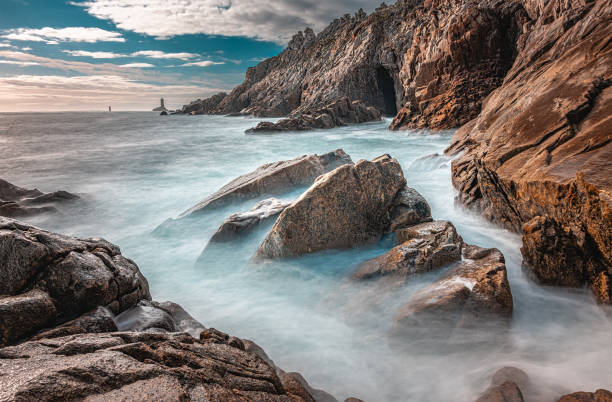 The Pointe du Raz, Brittany. Located at the end of land, this rocky cape faces the island of Sein. The giant waves of the Atlantic Ocean hit the rocks and the lighthouse at La Vieille
