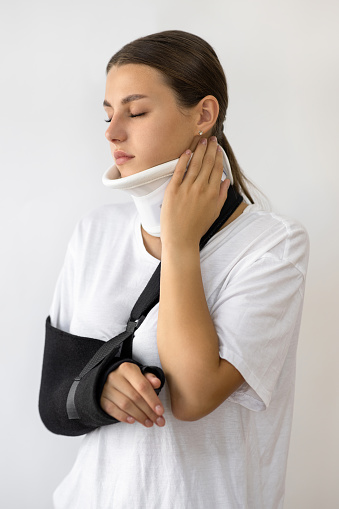 Woman in neck brace and arm sling