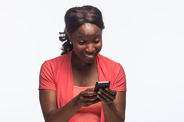 istock African American woman smiling and texting, horizontal 187920659