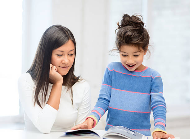 istock mother and daughter with book 187921890