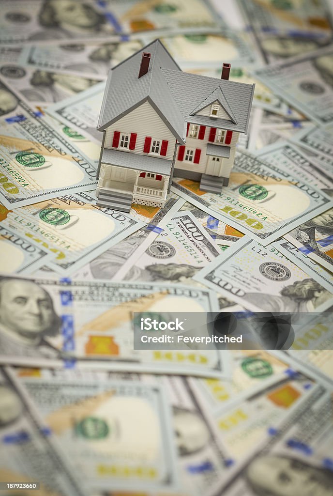 Toy house on top of one hundred dollar bills Small Model House on Newly Designed U.S. One Hundred Dollar Bills. Currency Stock Photo