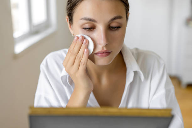 Woman using cotton pads for cleaning face